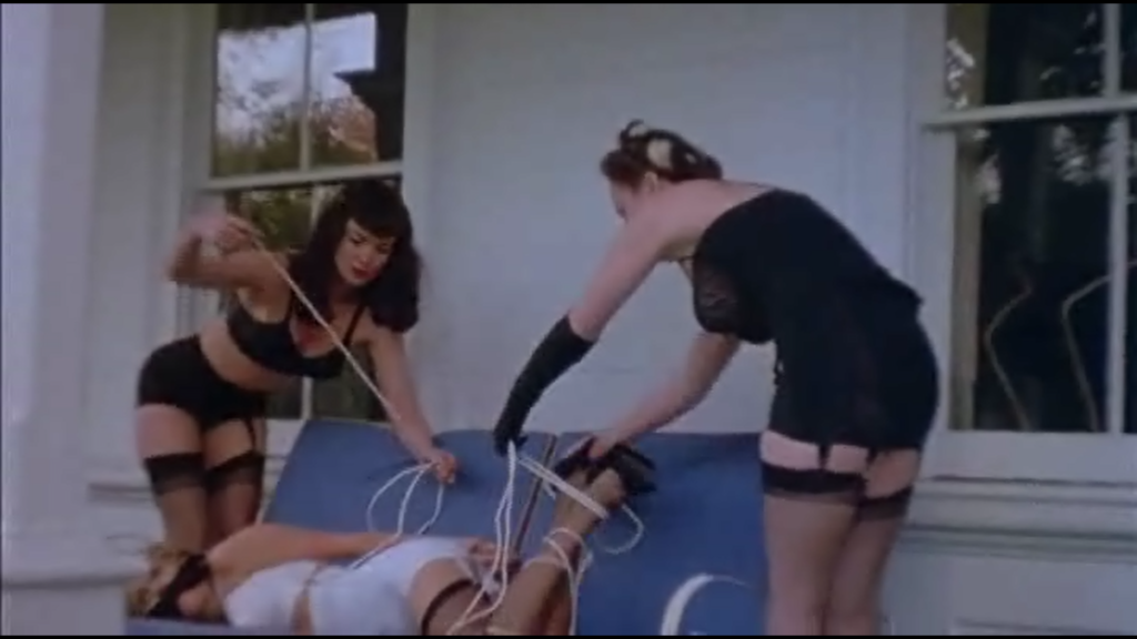 The Notorious Betty Page ties up a girl in her first acting gig